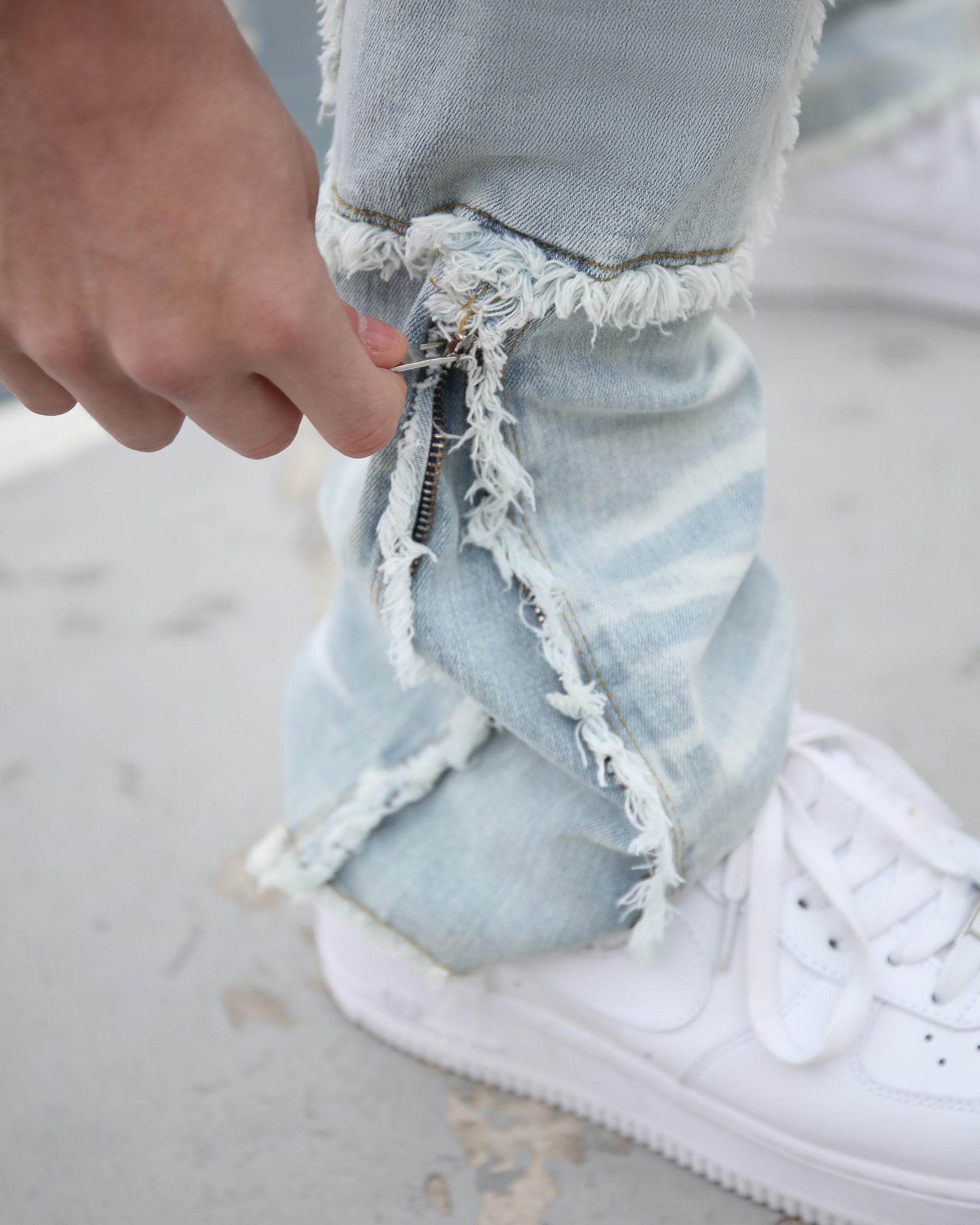 LOGEQI light blue distressed cargo pocket jeans with a frayed-edge zipper design on the ankle