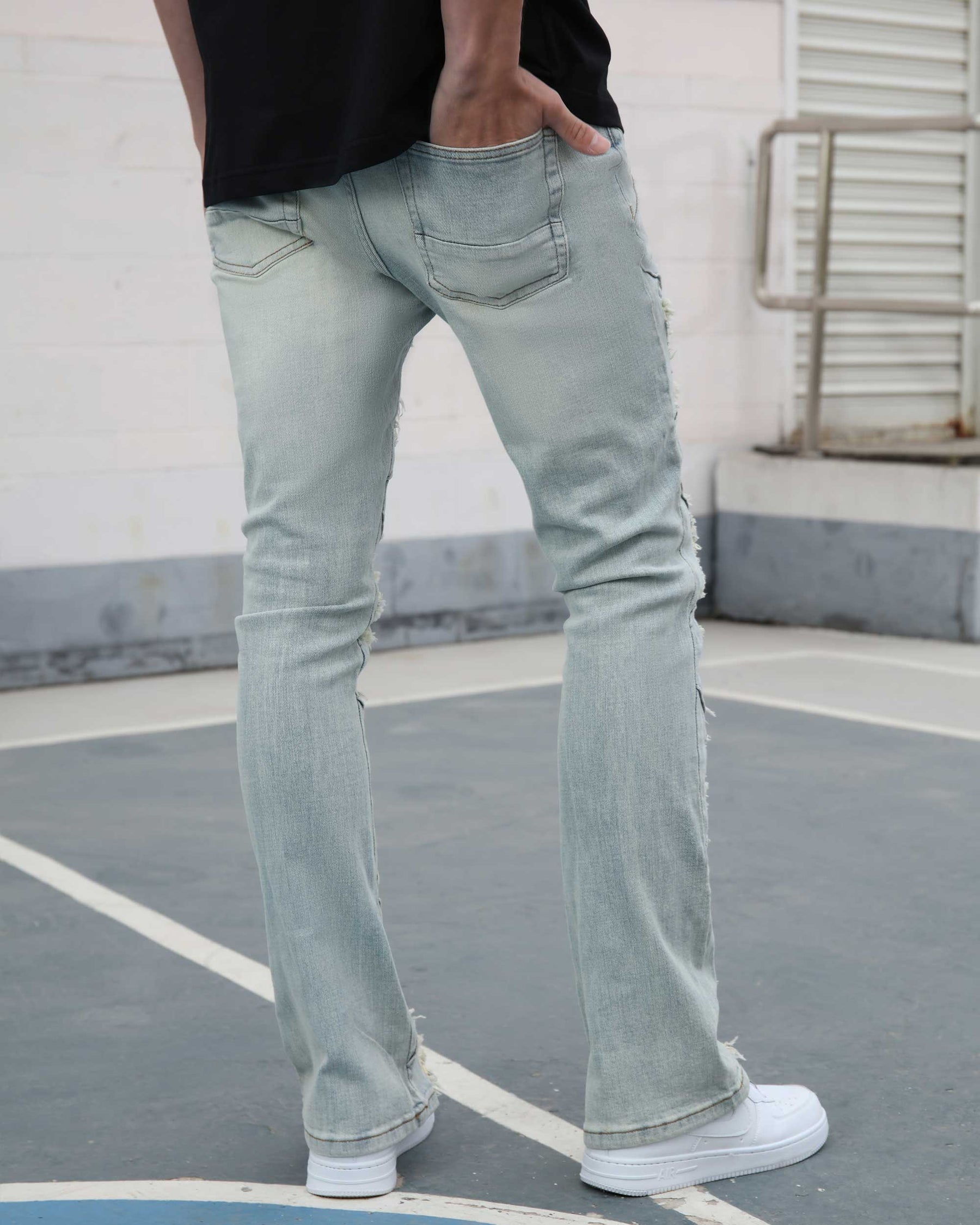 Flared Blue Jeans with Distressed and Large Ripped Detail
