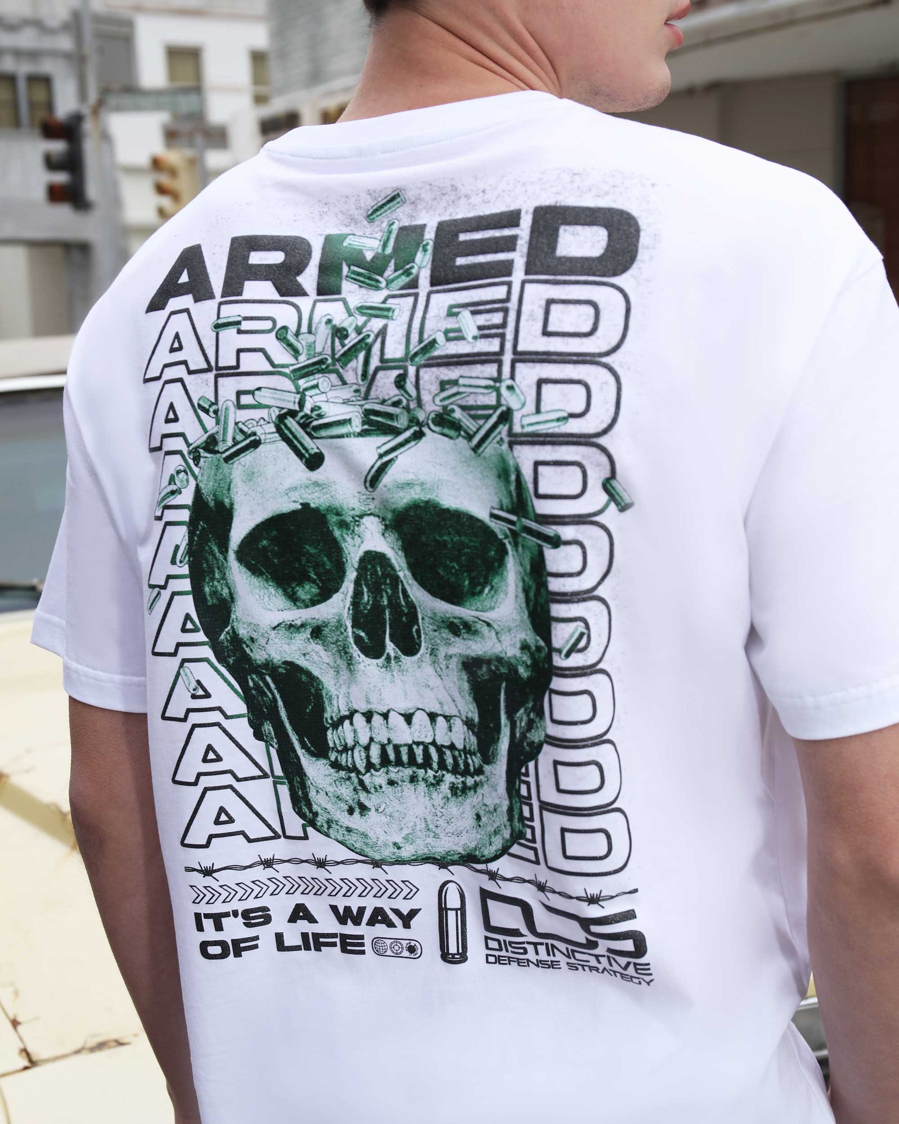 T-Shirts with Green Skull Graphic, Repeated "ARMED" Letters, and Bullet