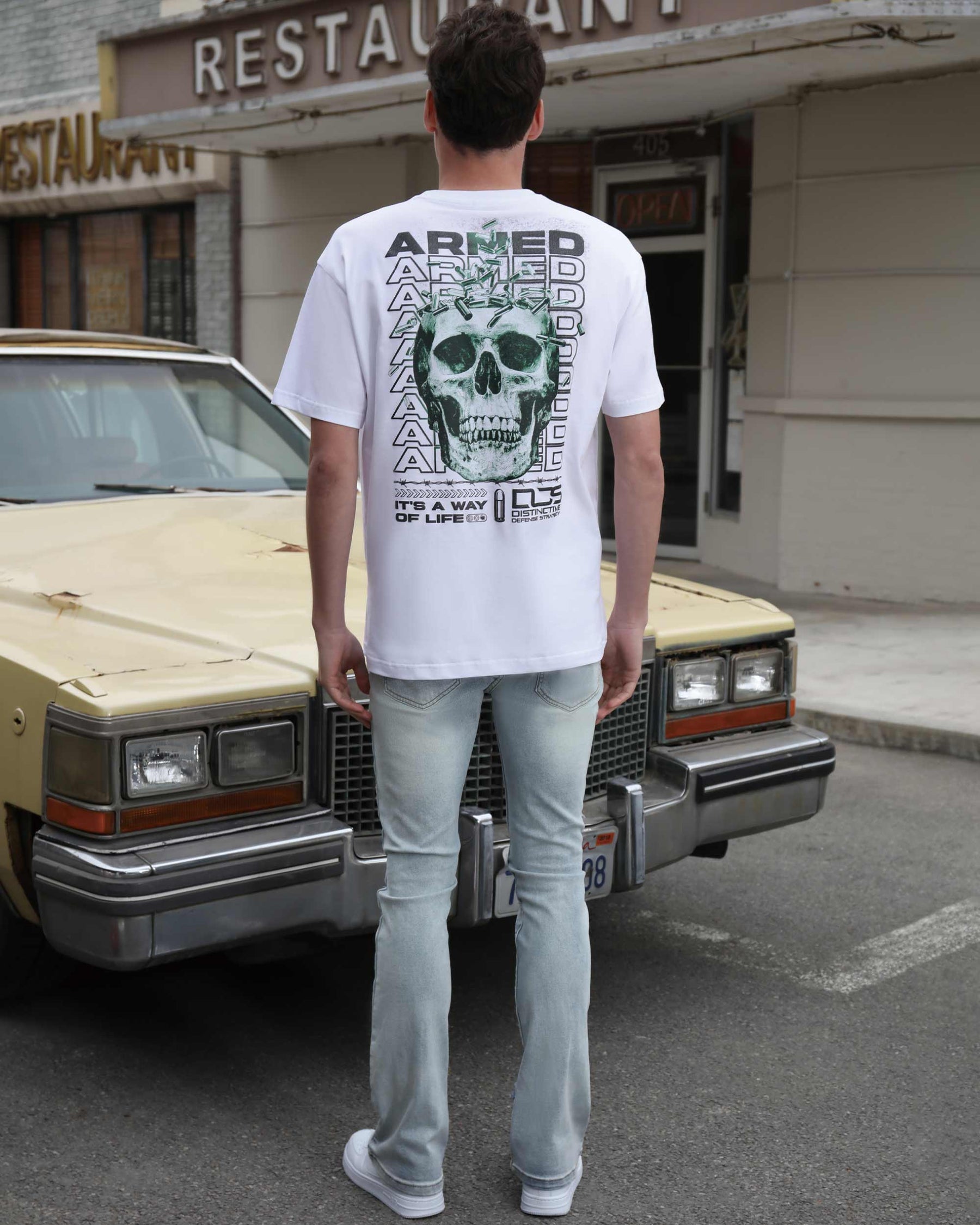 T-Shirts with Green Skull Graphic, Repeated "ARMED" Letters, and Bullet