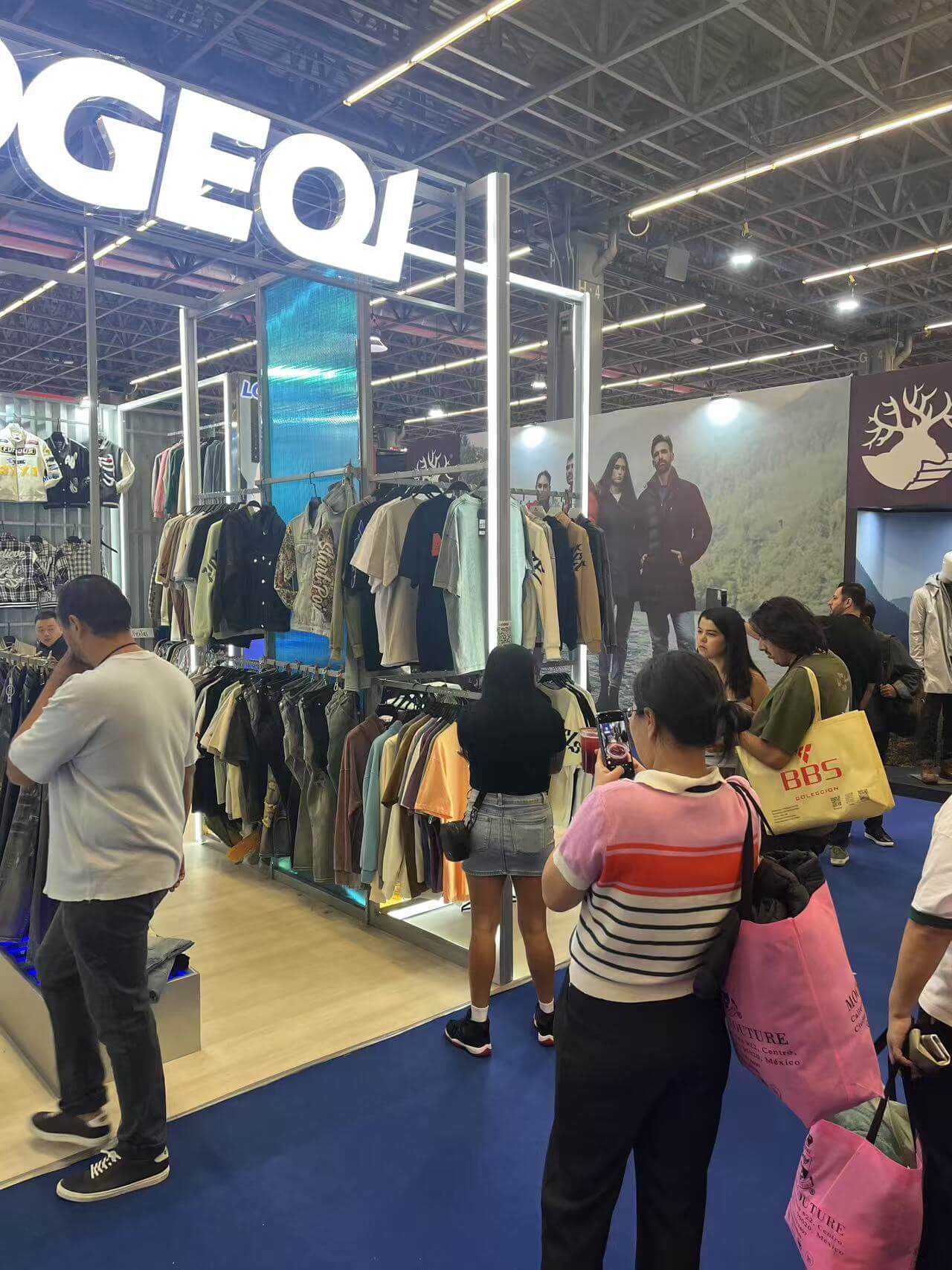 Customers visiting LOGEQI's stand at INTERMODA 2025 and taking pictures