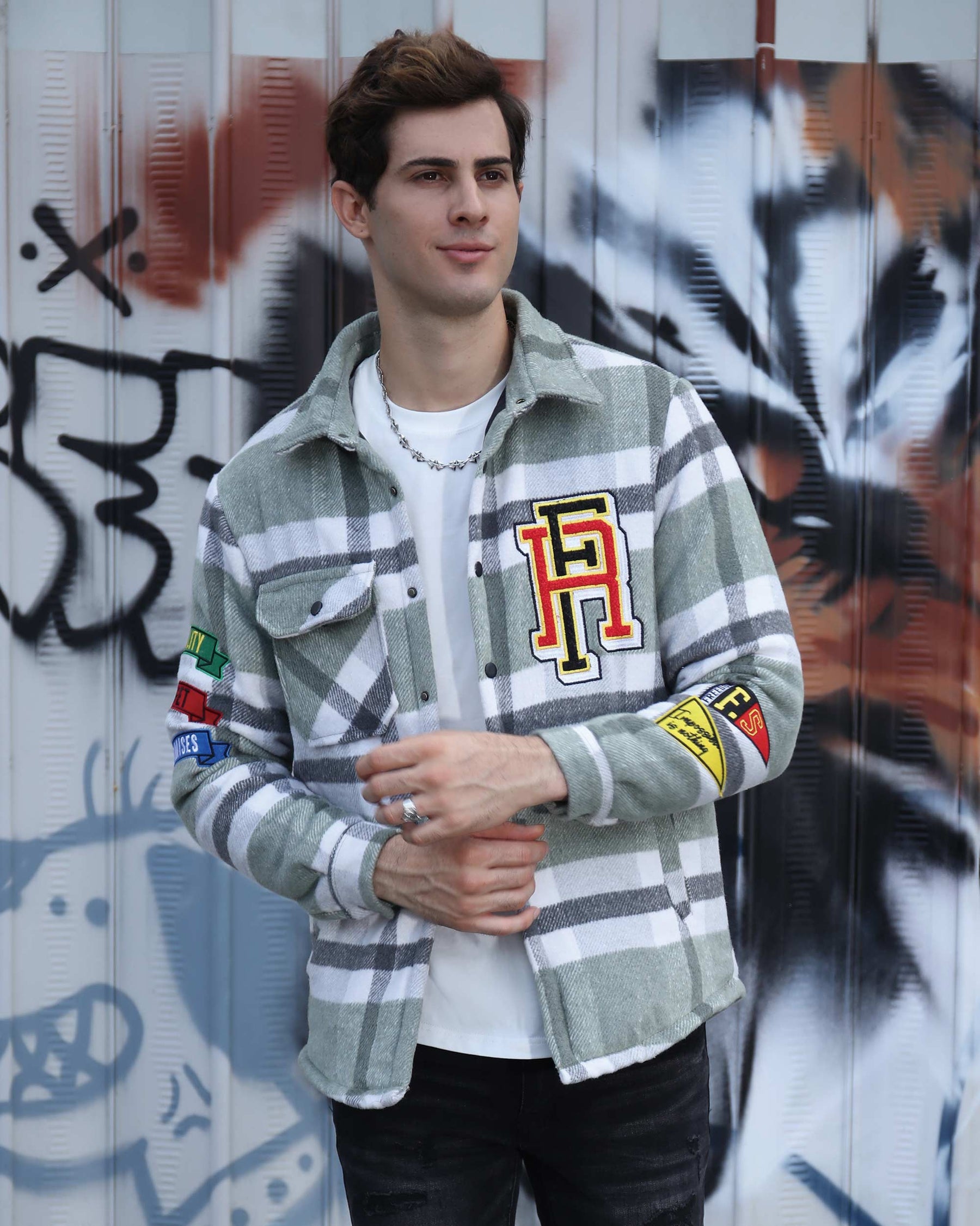 A handsome man wearing a LOGEQI green, black, and white plaid shirt jacket
