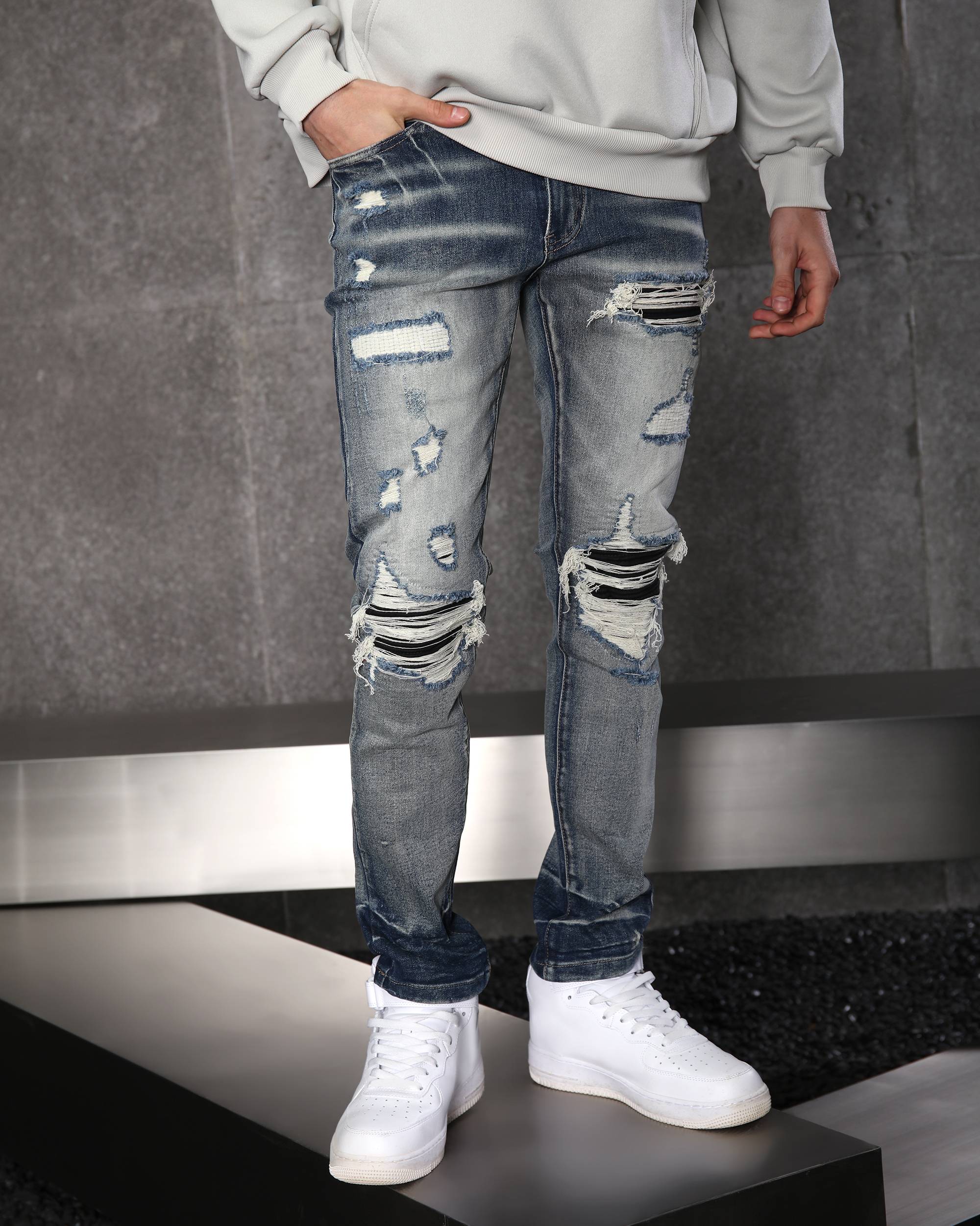 A guy wearing a LOGEQI blue slim fit ripped jeans