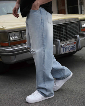Showing LOGEQI's men's blue knee-ripped baggy jeans with sleek front pockets to store daily essentials