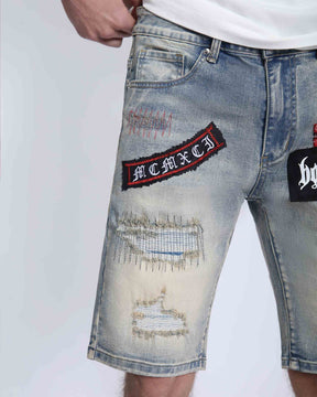 Distressed Denim Shorts with Gothic Skull Badge
