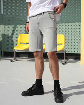 A man wearing LOGEQI's light blue vintage denim shorts on the street.
