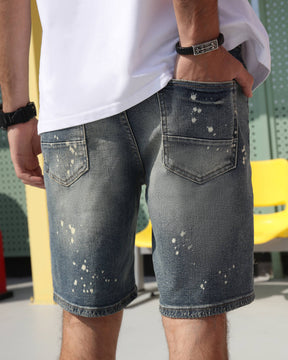 The detail of the back pockets of LOGEQI's blue denim jean shorts.