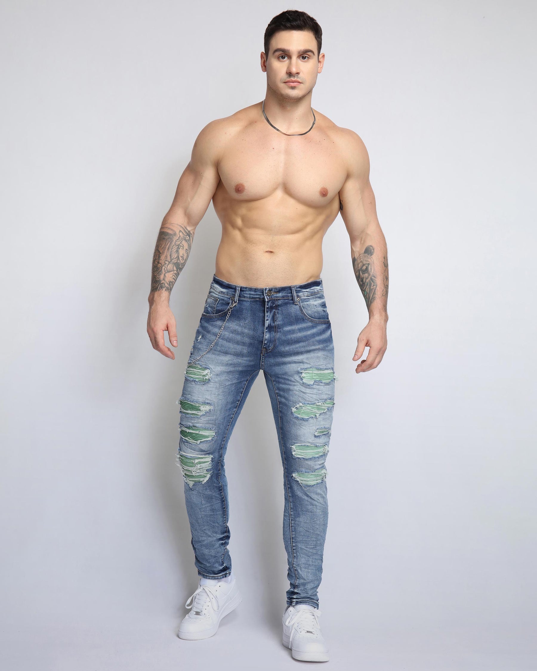 Large Ripped Blue Jeans with Green Patches