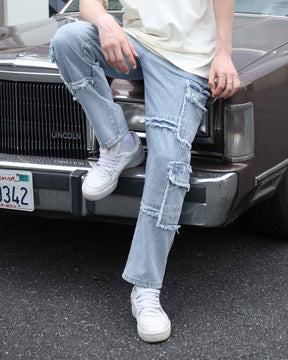 shot-on details of LOGEQI's street-style fringed-edge blue ripped distressed jeans with fringes.