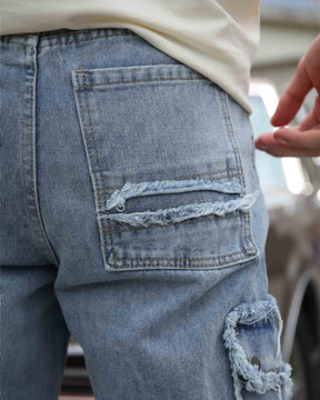 LOGEQI Street Style Fringed Edge Blue Ripped Baggy Jeans have back pockets with tears and distressing adorning the pockets